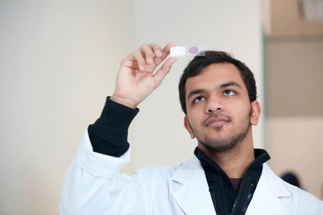 Science Marketing Photography Melbourne scientist looking at sample in a university lab