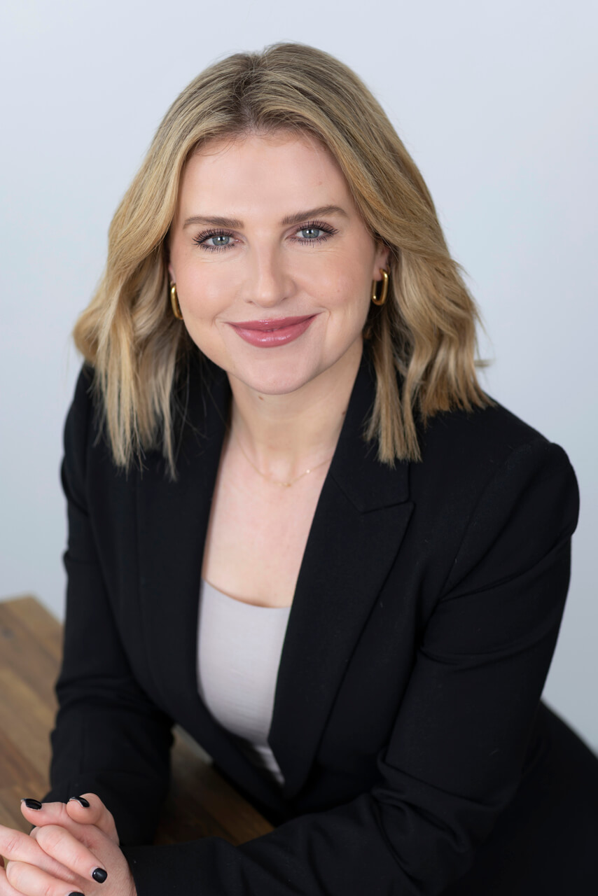 Studio headshot of a Melbourne professional with soft, flattering lighting. Smiling Melbourne professional in a studio setting