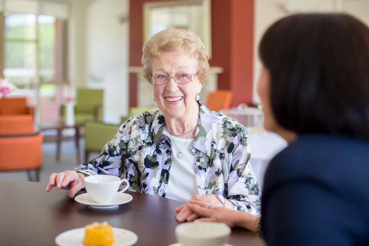 Resident and nurse sharing a moment in care facility in Melbourne captured for aged care facility marketing