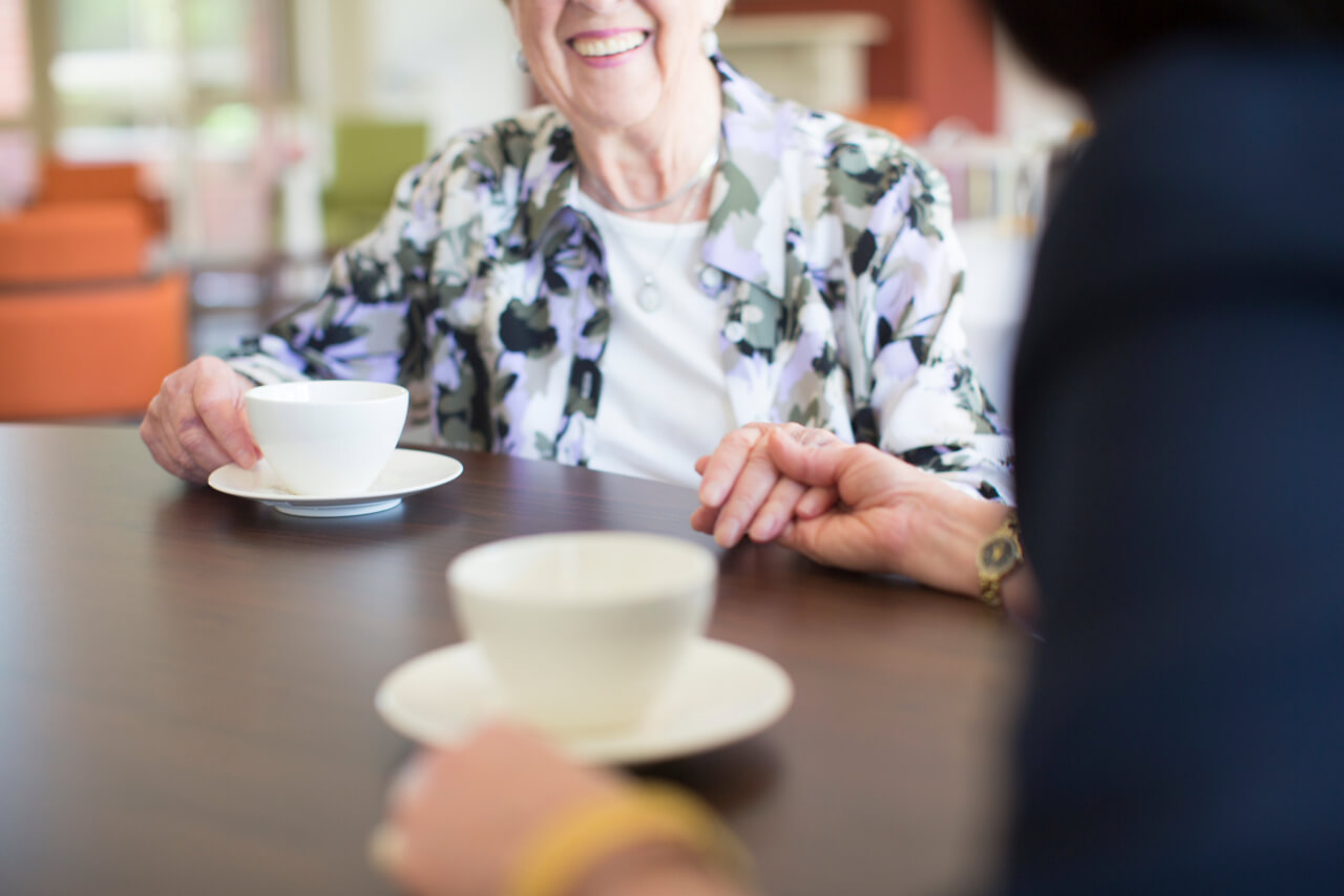 Resident and nurse sharing a moment in care facility in Melbourne captured for aged care facility marketing
