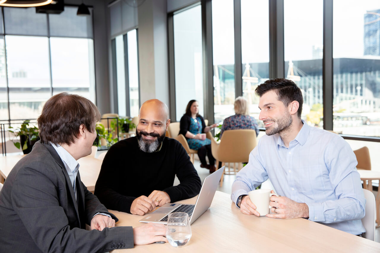Workplace Photography Colleagues in casual gathering in corporate workplace captured by Melbourne Photographer