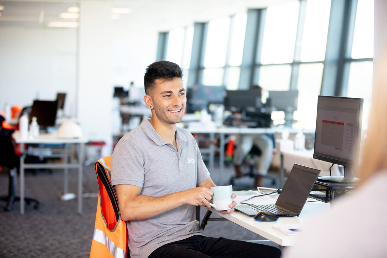 casual corporate photography Engineer in melbourne workplace having a coffee
